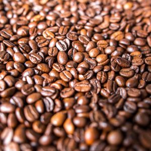 Macro shot of roasted coffee beans representing Alto Roble Honey Tarrazu