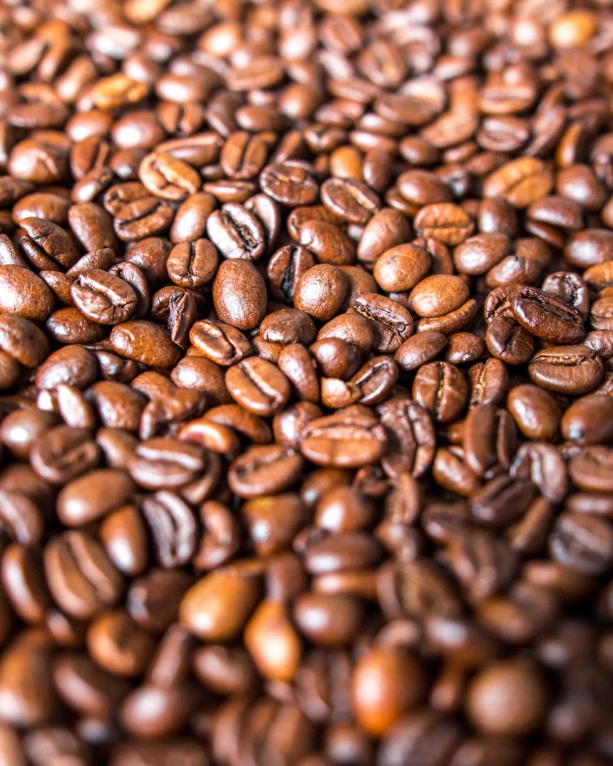 Macro shot of roasted coffee beans representing Alto Roble Honey Tarrazu