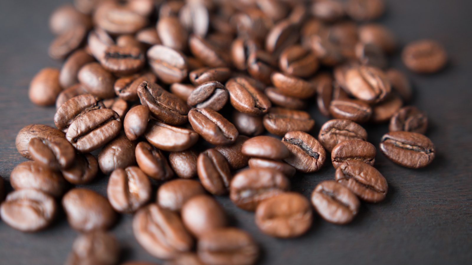 Close-up of glossy roasted coffee beans representing Kiaruthi Nyeri AA