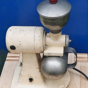 Vintage-style electric coffee grinder with a round motor housing